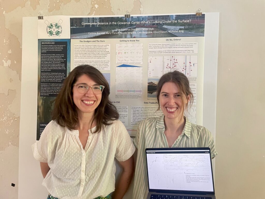 Corinne and Erica smile & stand in front of the poster titled "Community Science in the Gowanus Canal: What's Lurking Under the Surface?" Erica is also holding a laptop with a prototype of a website to display data about water quality in the Gowanus.